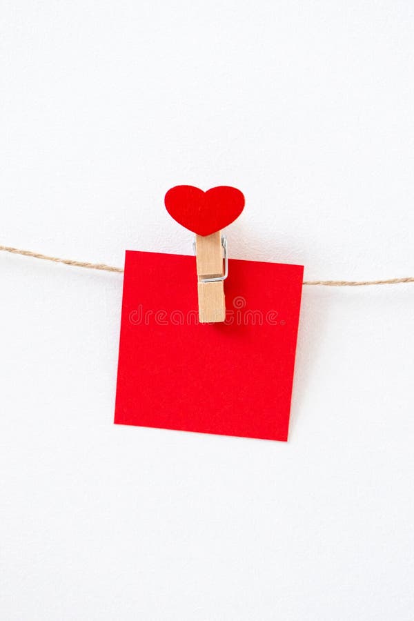 Template empty postcards with tiny clothespins on a red background