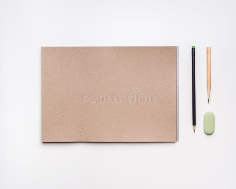Open Craft Paper Sketchbook with Pencils and Eraser on White Background