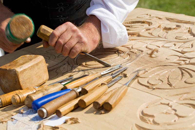 Craftsman carving wood royalty free stock photography