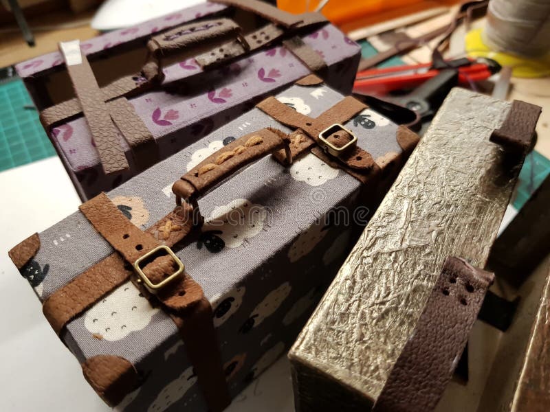 Craftsman makes miniature doll suitcases stock image