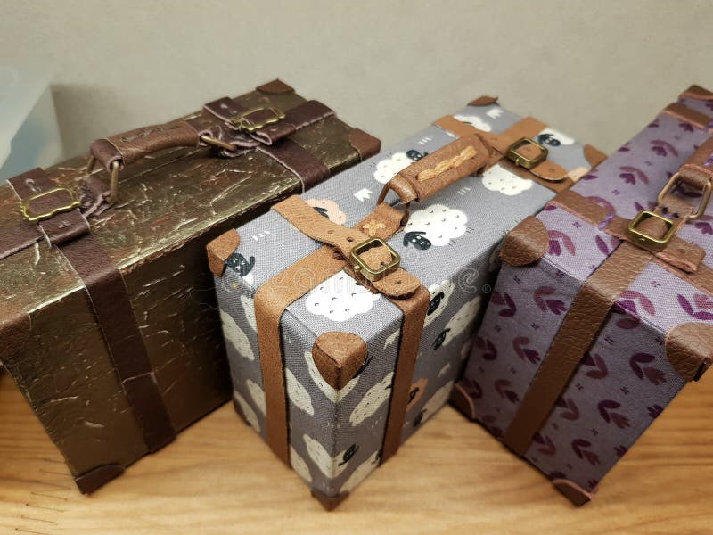 Craftsman makes miniature doll suitcases stock images
