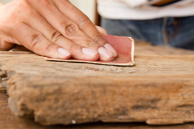Craftsman Run the sandpaper across the wood surface stock photos Craftsman Run the sandpaper across the wood surface stock photos