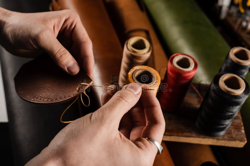 Craftsman Sews Genuine Leather Using Needle and Thread for Creation