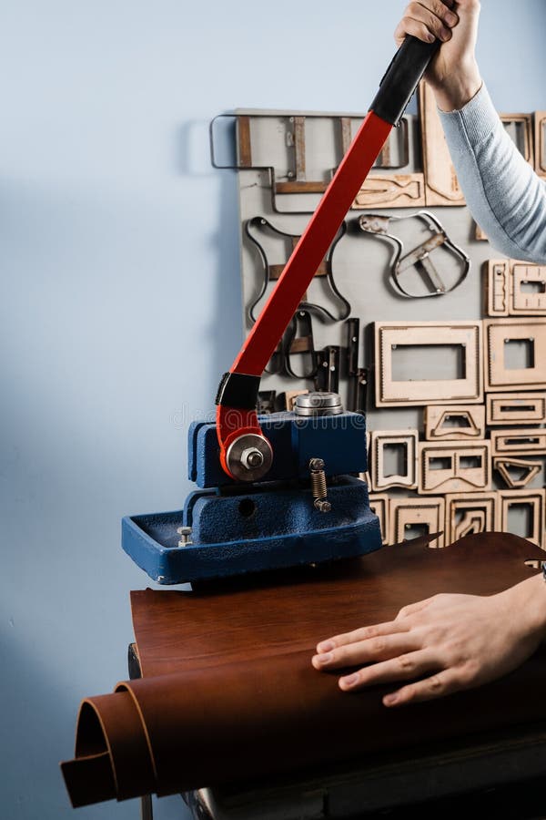 Craftsman is Using Leather Punching Press for Creating Forms from