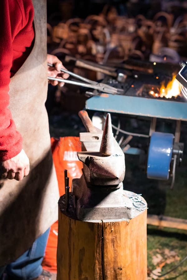 A Craftsman Working with Fire and a Hammer on a Glowing Iron. Middle