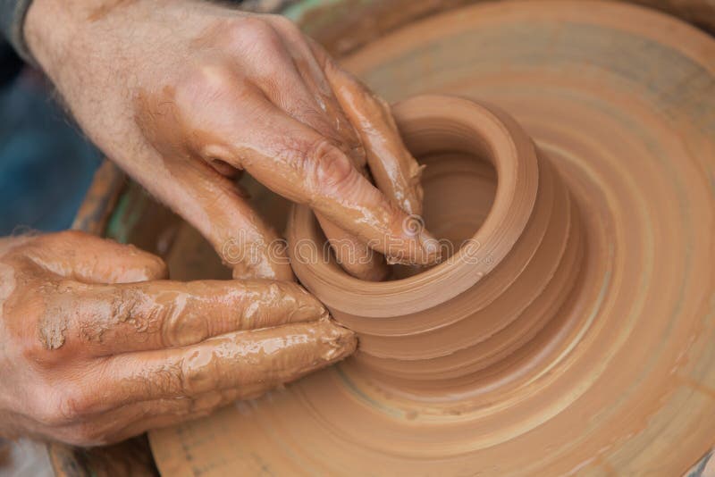 Craftsman works in clay pot