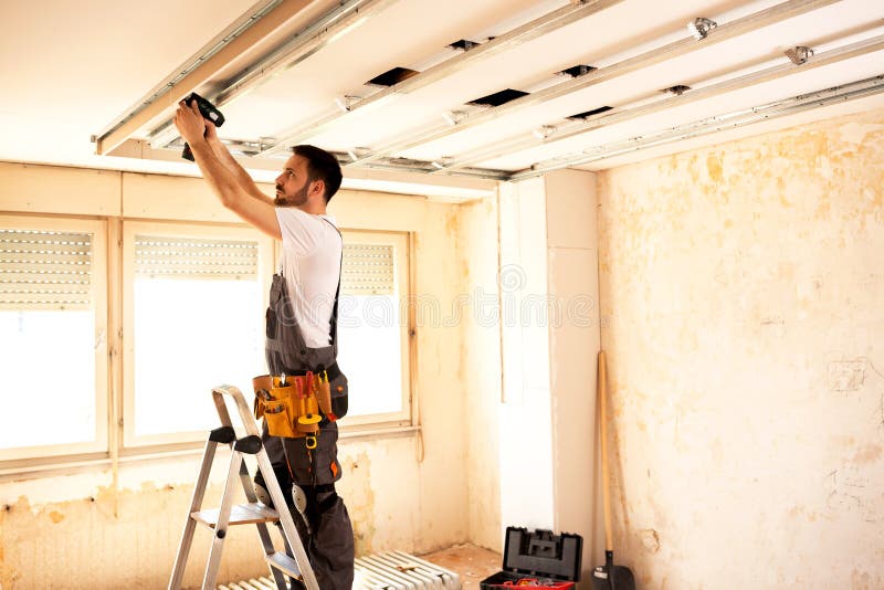 Crafty worker arranging ceiling construction stock photos Crafty worker arranging ceiling construction stock photos
