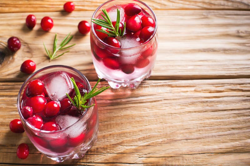 Cranberries cocktails with ice berries and rosemary