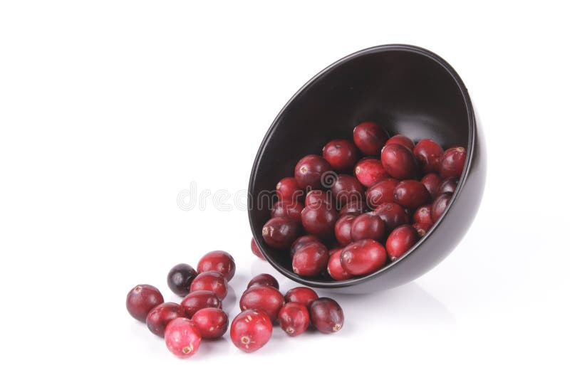 Cranberries spilling out of a Black Bowl