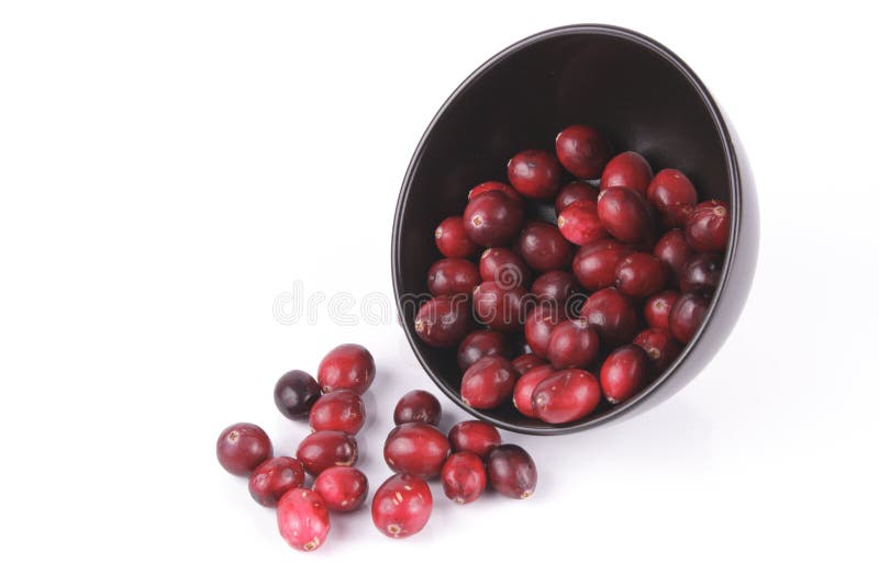 Cranberries spilling out of a Black Bowl