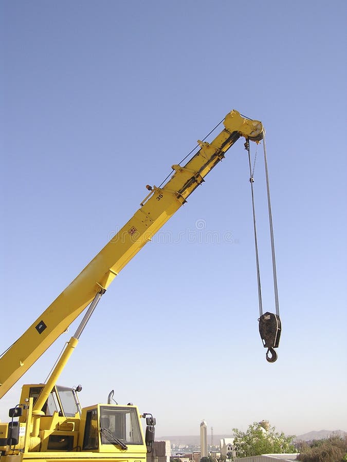 Crane on the blue sky of Aswan, Egypt used to carry granite blocks for the International symposium. Working granite stock images, royalty-free photos and pictures