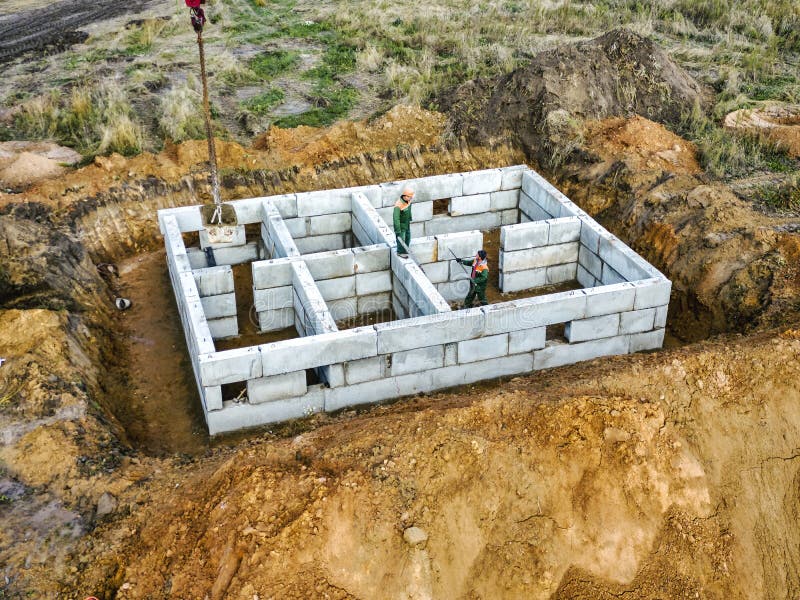 Crane Assembles Foundation Blocks at the Construction Site. View from