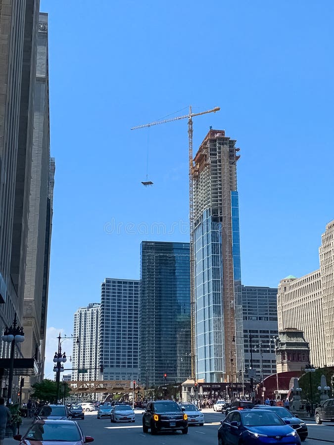 Crane at Building Under Construction Lifting Window Material in Chicago