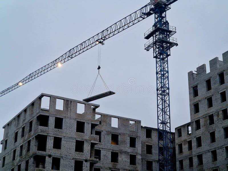 Crane at a Construction Site Lifts a Concrete Slab. Stock Image Image