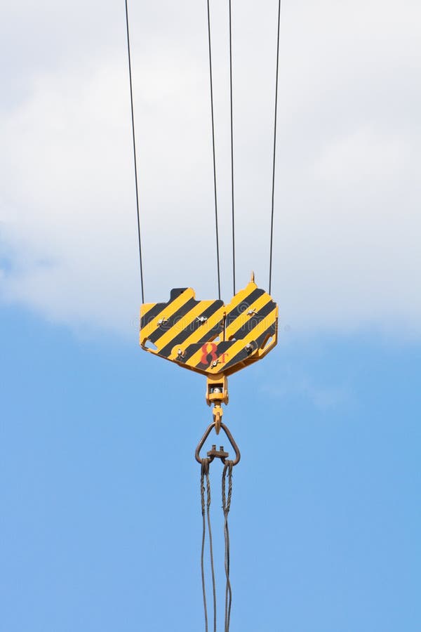 Crane hook over blue sky