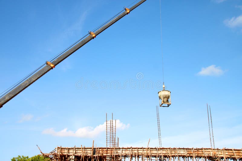 Crane lifting mixed concrete container stock photo Crane lifting mixed concrete container stock photo