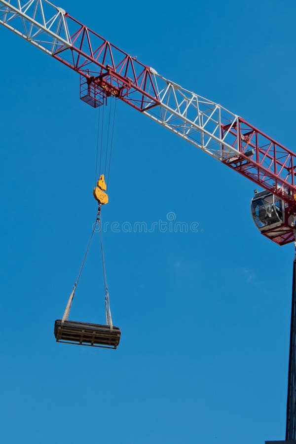 The Crane Lifts a Heavy Load on a Hook. Stock Photo Image of lifts