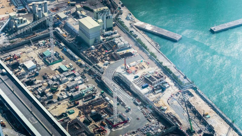 Crane working at building construction near the harbor. Hong Kong. Time lapse