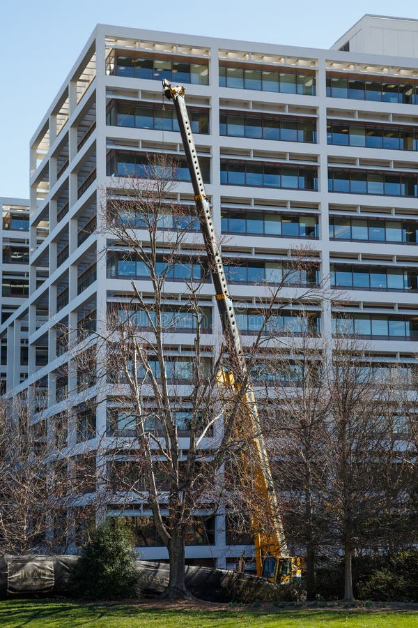 Crane Working on White Terraced Office Building