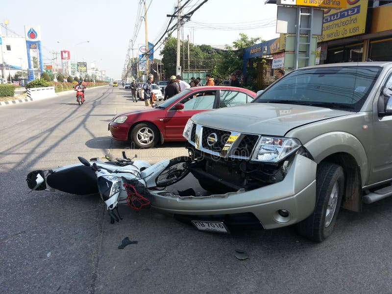 CHIANGMAI, THAILAND-JANUARY 10, 2013: Crash Accident Pickup Truck with Motorcycle at roadside in Chaingmai, Northern Thailand. CHIANGMAI, THAILAND-JANUARY 10, 2013: Crash Accident Pickup Truck with Motorcycle at roadside in Chaingmai, Northern Thailand.