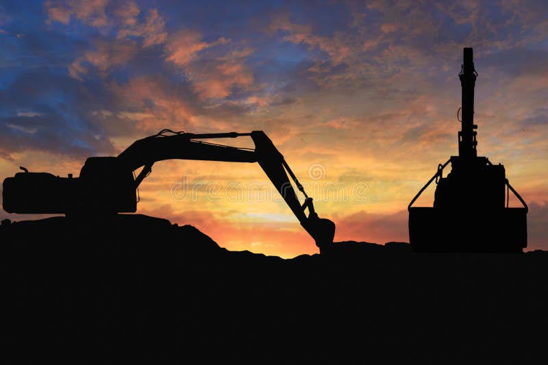 Crawler excavators silhouette are digging the soil in the construction site. With blue sky and clouds of on sunset background. Track hoe construction excavator stock images, royalty-free photos and pictures