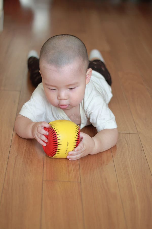 Crawling baby playing toy on floor