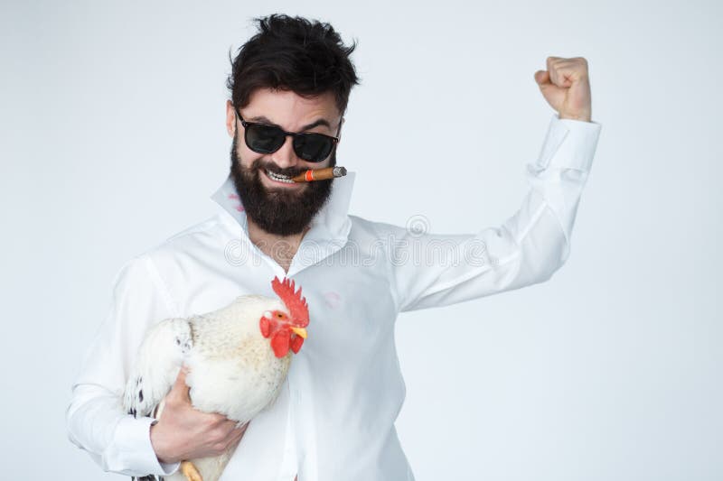 Crazy insane man in with chicken and cigar stock images Crazy insane man in with chicken and cigar stock images