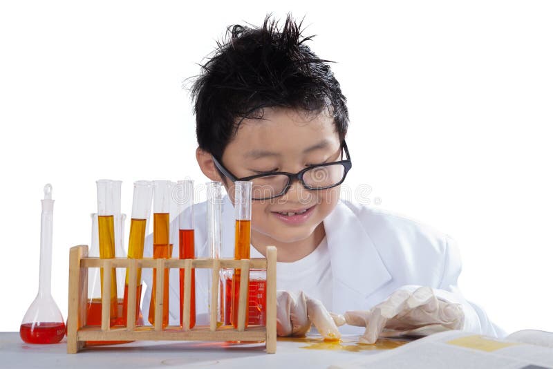 Portrait of a male little scientist touching liquid chemistry while wearing gloves on desk. Portrait of a male little scientist touching liquid chemistry while wearing gloves on desk