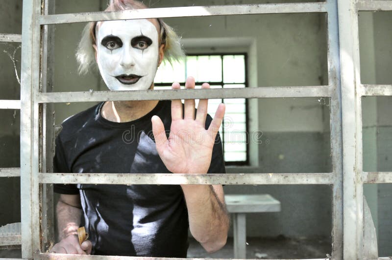 Crazy man dressed as a clown in an abandoned house in Italy