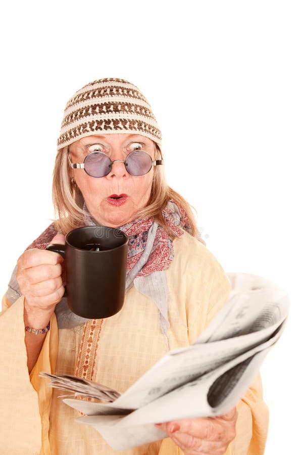 Crazy new age woman in a yellow robe with coffee stock image