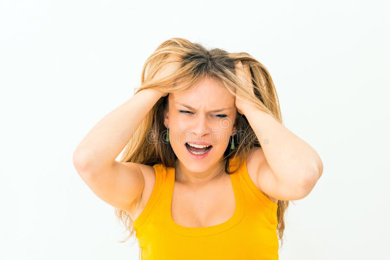 Crazy woman making a face and pulling hair royalty free stock photo