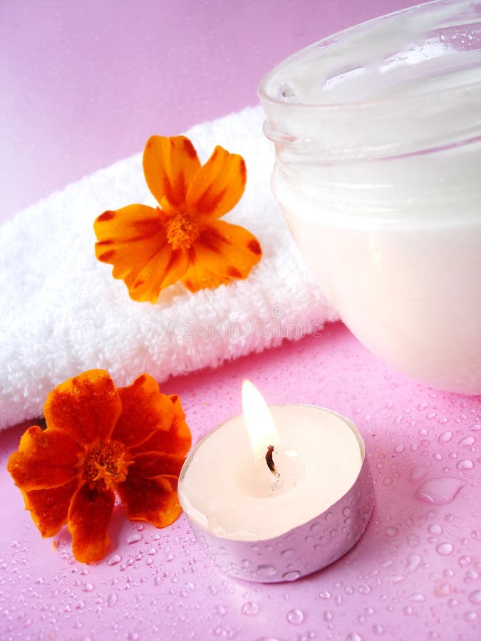 Cream and candle with flowers