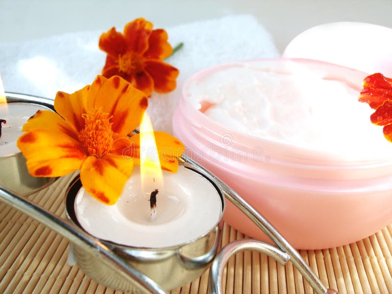 Cream and candle with flowers