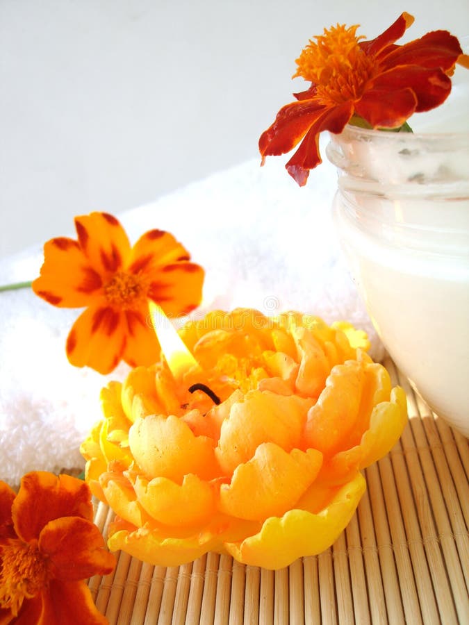 Cream and candle with flowers