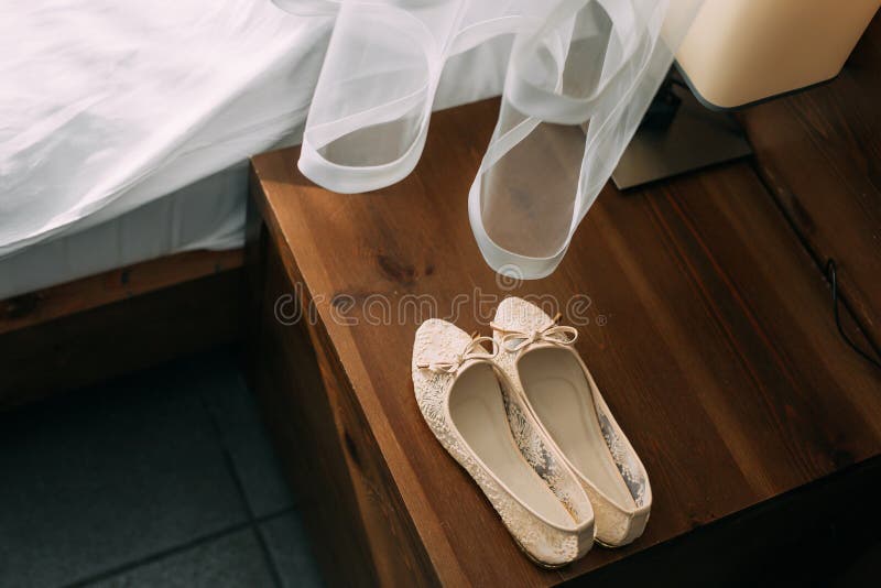 Cream Shoes of the Bride on Green on a Wooden Table Table Stock Image ...