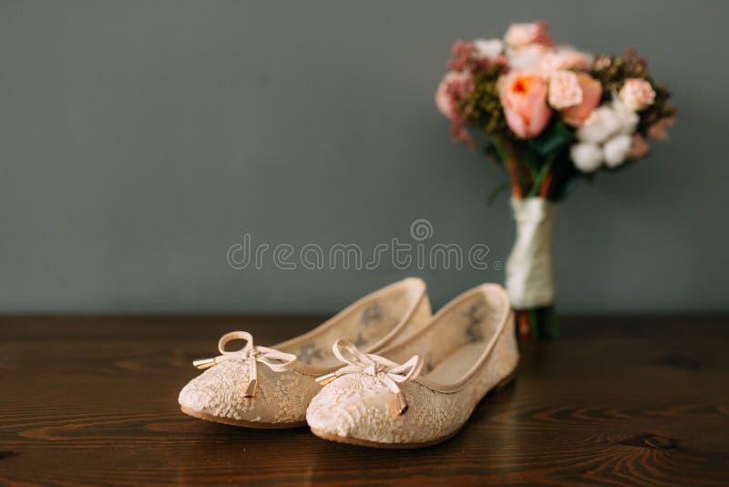 Cream Shoes of the Bride on Green on a Wooden Table Table Stock Photo ...