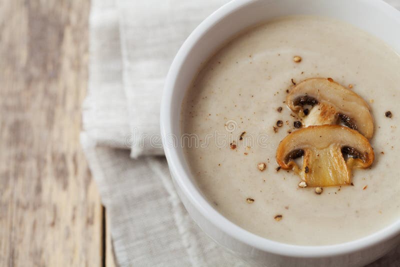 Cream soup with mushrooms champignon and potato in white bowl stock image Cream soup with mushrooms champignon and potato in white bowl stock image