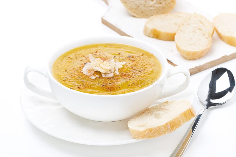 Cream soup of yellow lentils with bread, isolated