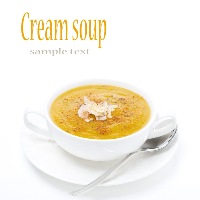 Cream soup of yellow lentils in a white bowl, isolated