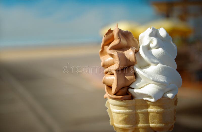 2 flavor soft ice cream; beach promenade in the background. 2 flavor soft ice cream; beach promenade in the background