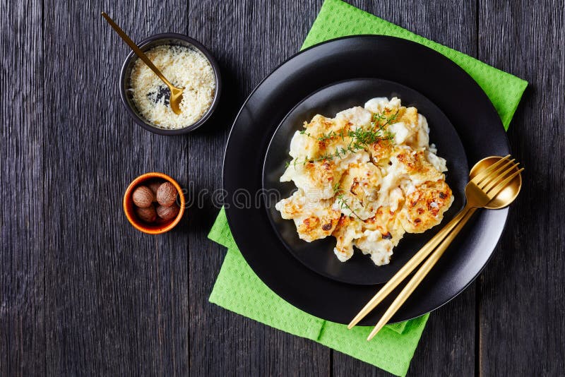 Creamy cauliflower cheese on a plate, copy space stock photos