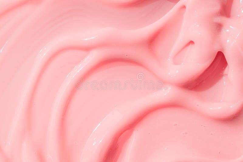 .Creamy pink skincare lotion mousse product closeup. Peach cream, moisturizer spread, sunscreen cosmetic smear