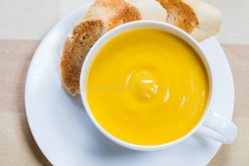 Creamy pumpkin soup with lightly toasted baguette