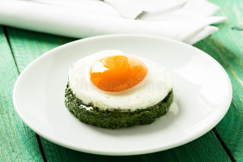 Creamy Spinach with Fried Egg Stock Image Image of straw, cooking