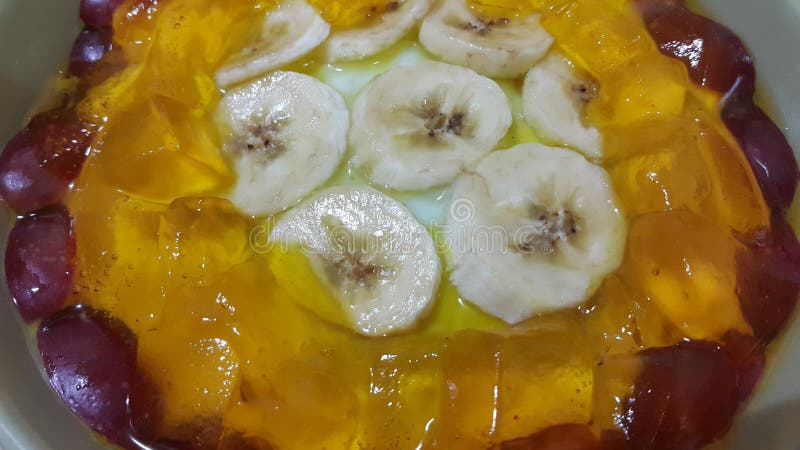 Creamy tasty sweet custard with banana pieces layered on surface. A close up top view of home made custard, a dairy products for dessert after meal stock images Creamy tasty sweet custard with banana pieces layered on surface. A close up top view of home made custard, a dairy products for dessert after meal stock images