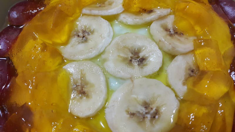 Creamy tasty sweet custard with banana pieces layered on surface. A close up top view of home made custard, a dairy products for dessert after meal stock photo Creamy tasty sweet custard with banana pieces layered on surface. A close up top view of home made custard, a dairy products for dessert after meal stock photo