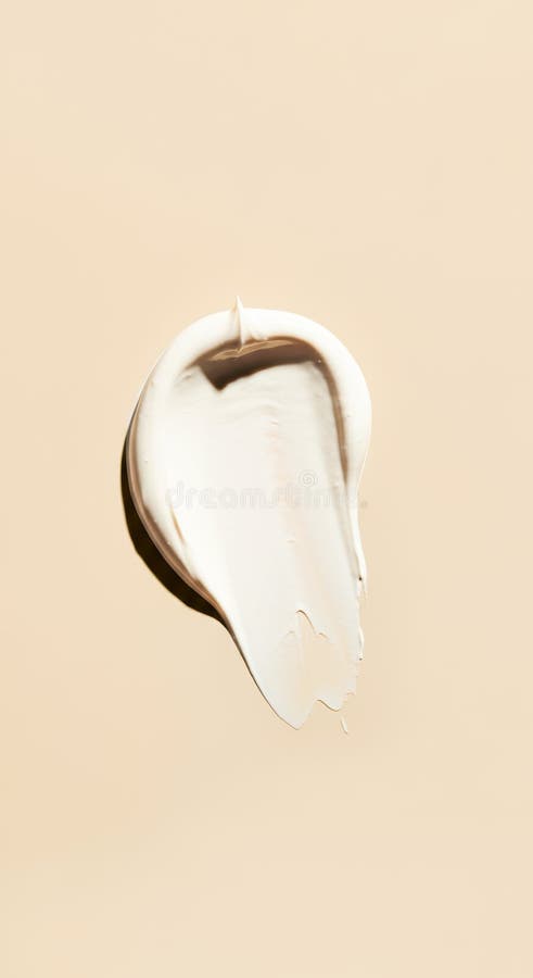 Creamy texture of beige lotion against pastel background royalty free stock images