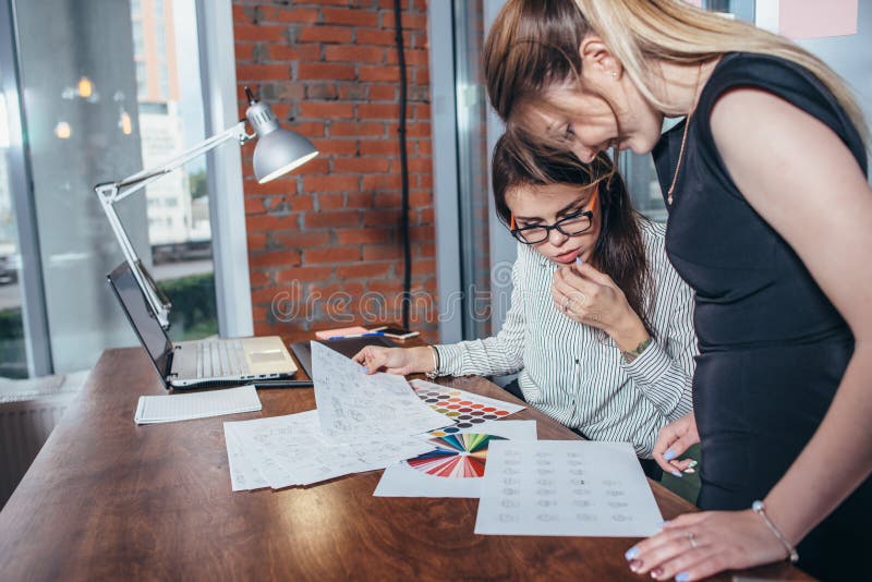 Creatief team van grafische ontwerpers die aan nieuw project werken die kleurenmonsters en schetsen van het ontwerp van websiteel stock afbeeldingen Creatief team van grafische ontwerpers die aan nieuw project werken die kleurenmonsters en schetsen van het ontwerp van websiteel stock afbeeldingen