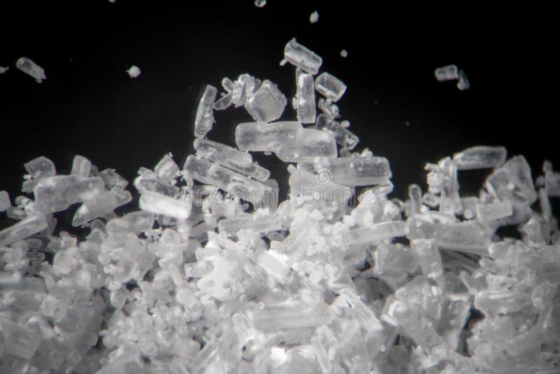 Creatine crystals by microscope looks like methamphetamine. Athletic dietary supplement in details close-up. White cristales