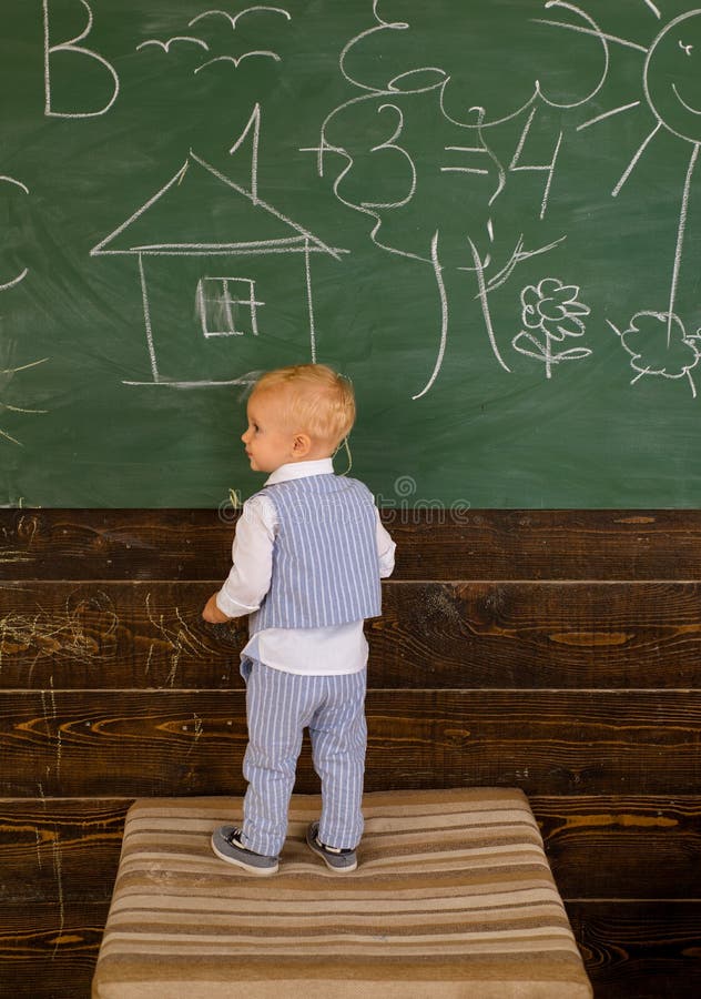 Creative artist painting doodle on classroom chalkboard. Little artist boy creating picture on school day. I was created stock photography Creative artist painting doodle on classroom chalkboard. Little artist boy creating picture on school day. I was created stock photography